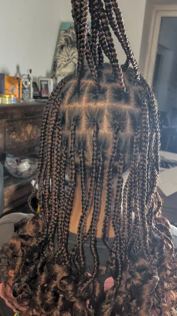 Box braids — half up with spiral curled ends
