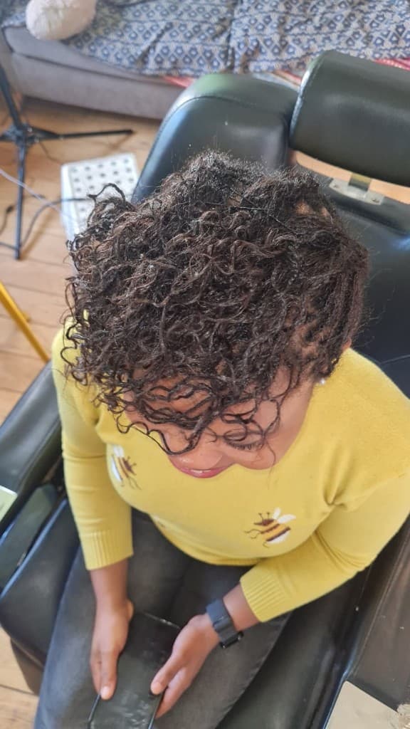 Copper-toned sisterlocks in barrel rows