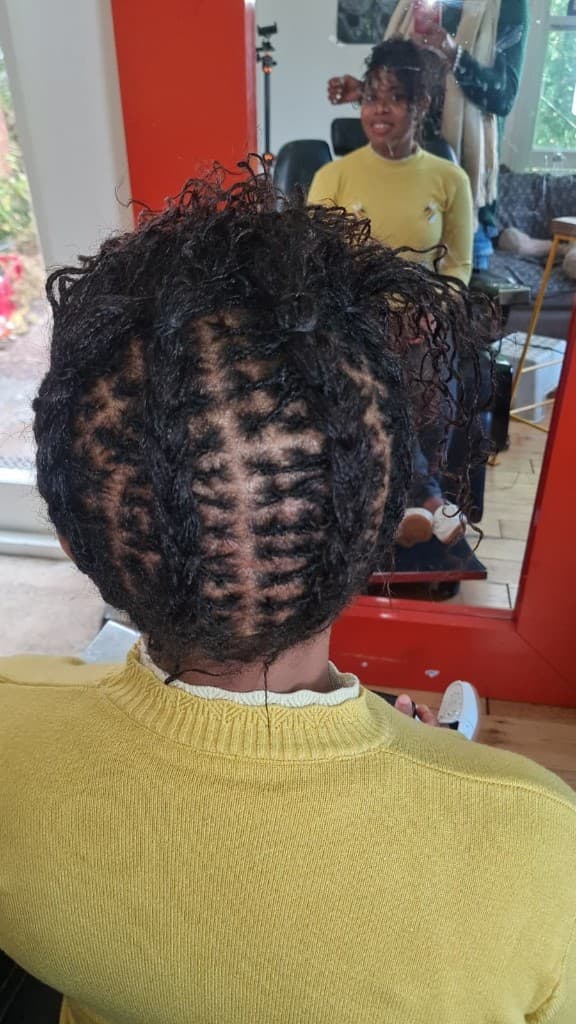 Sisterlocks with clean nape tracks and precise grid parting — Vichi Locs, Bristol
