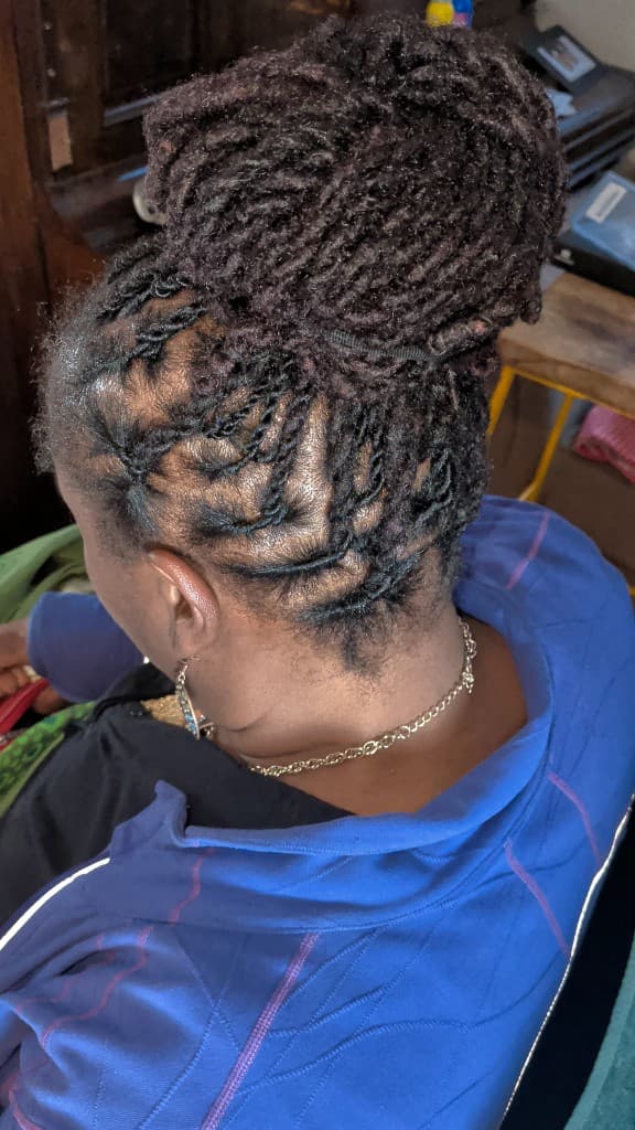 Traditional locs twisted up into a high bun